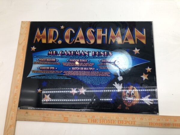 A Top Glass for Aristocrat Mark 5 games, Mr Cashman poster on a ruler.