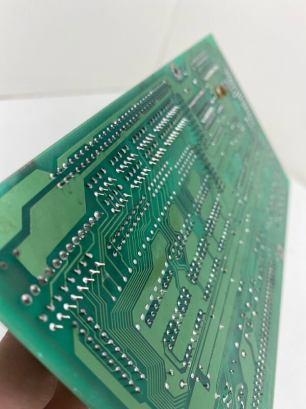 A person is holding a Power Control Board for Konami Gaming, Konami Part GG9P1 Interface Buttons/Door/7 Segment Board. GETT Part PCB114.