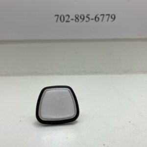 A small Black Plastic Push button, 4 sided trapezoid produced by GamesMan and backlit, New GETT Part BTN206.