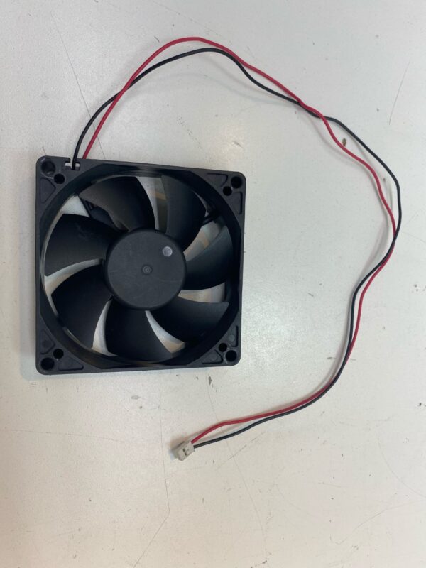 A 12V x .12A Cooling Fan on a white surface.