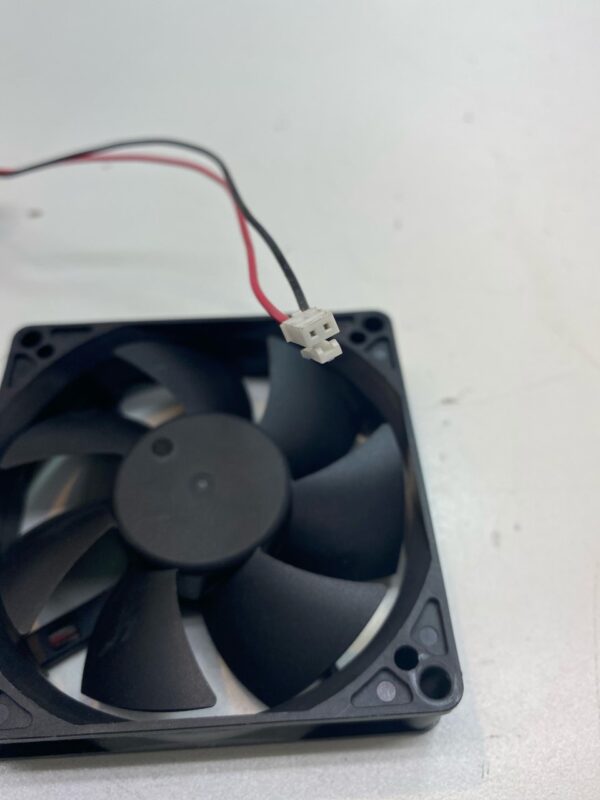 A small 12V x .12A Cooling Fan with wires attached to it.