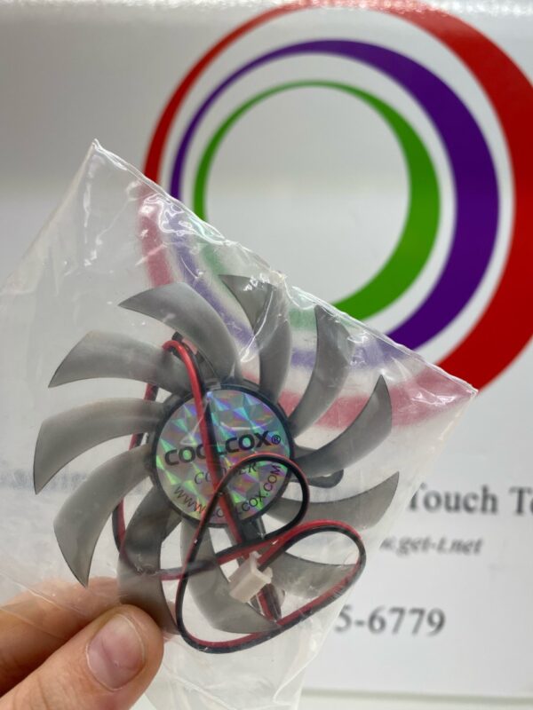A person holding a 12V x .31A Cooling Fan in a plastic bag. CoolCox Part CC8010H2125. FrameLess Fan. 2-wire, Tiny Connector. GETT Part Fan265.