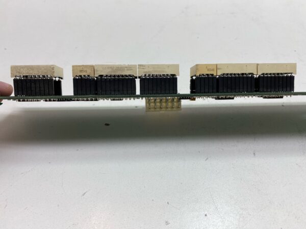 A person is holding a piece of an IGT S2000 Machine 960 Stepper Seven Segment Display w/ Long Bracket. IGT Part 75117900. GETT Part LED128 board.