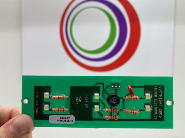 A person is holding up a card with the Kiesub Electronics K624-DP LED Replacement Board for Display Panel on Bally 6000 circular logo on it.