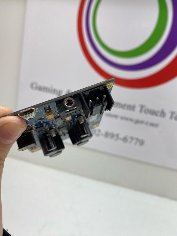 A person holding up a Power Control Board for use with Cadillac Jack Games. Cadillac Jack part # 050924. GETT Part PCB119 with a logo on it.