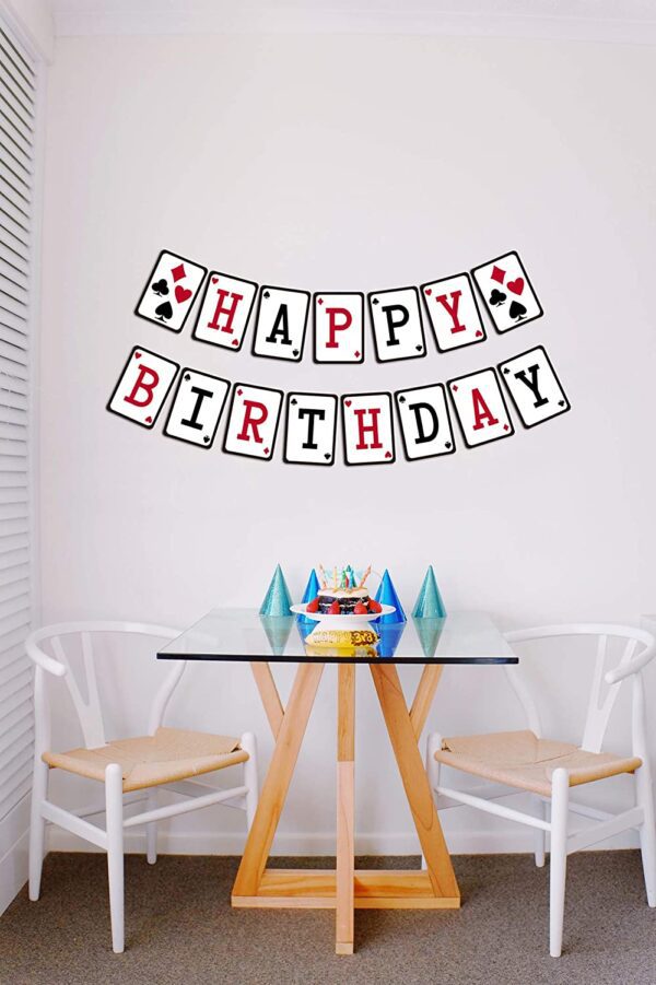 A Casino Birthday Banner, Casino Night Poker Happy Birthday Sign, Adult Red Black Bday Party Bunting hangs on a wall in a dining room.