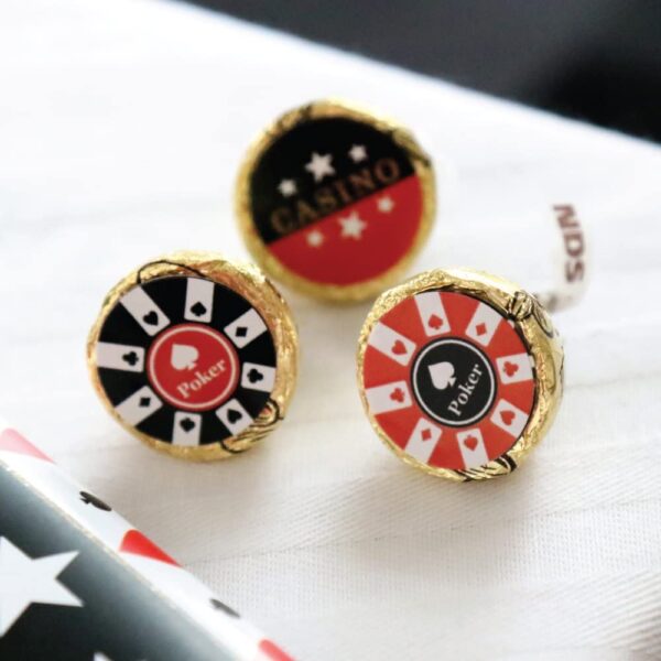 Two Las Vegas - Casino Party Round Candy Sticker Favors - Labels Fit Hershey’s Kisses (1 Sheet of 108) on a table with an american flag.