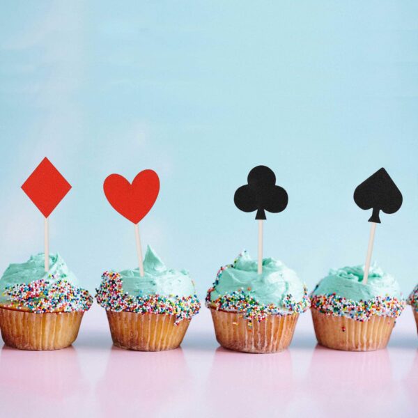 A row of Donoter 36 Pcs Glitter Casino Night Poker Theme Cupcake Toppers Las Vegas Party Cake Picks Food Decoration on top.
