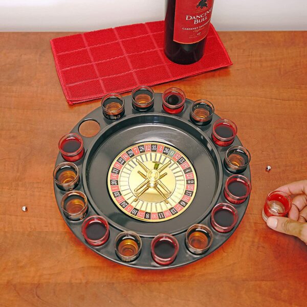 A person is holding a Novelties Shot Glass Roulette Complete Set drinking game, 16PCS, Red/Black GETT Part CQG103 on a table.
