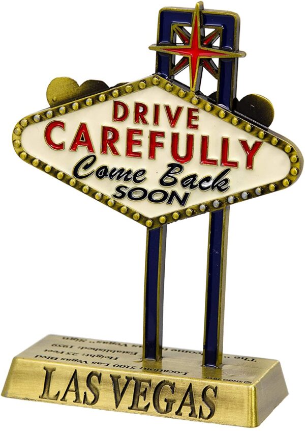 A Las Vegas Sign Replica 5" - Welcome to Las Vegas Sign (5", Bronze) with the words drive carefully come back.