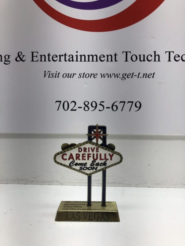 A Las Vegas Sign Replica 5" - Welcome to Las Vegas Sign (5", Bronze) with the words driving & entertainment touch technologies.