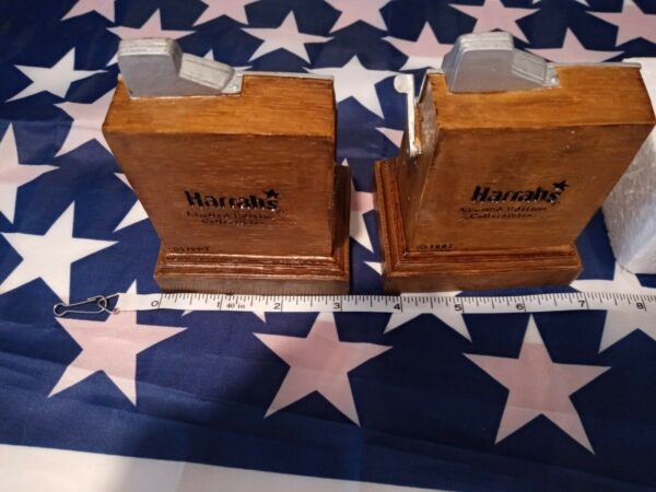 Two Harrah's 1997 Limited Edition Set Of Two Miniature Slot Machine Bookends next to an american flag.
