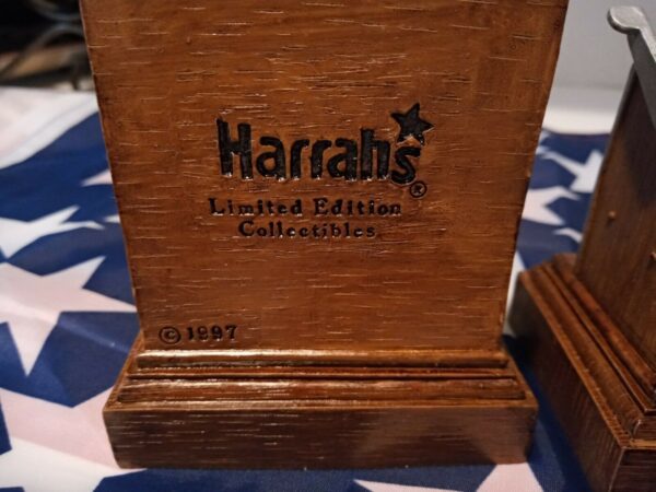 Two wooden boxes with the words Harrah's 1997 Limited Edition Set Of Two Miniature Slot Machine Bookends on them.