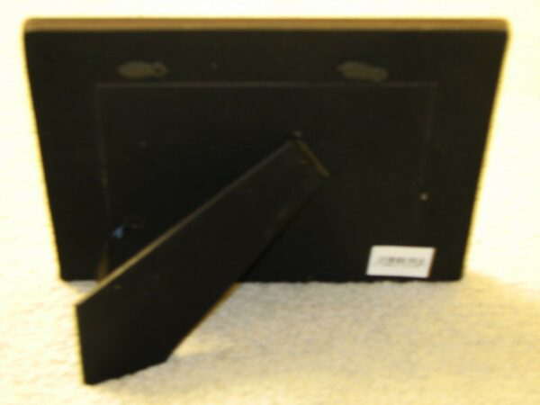 A black plastic box with a LAS VEGAS SOUVENIR PHOTO FRAME on it.
