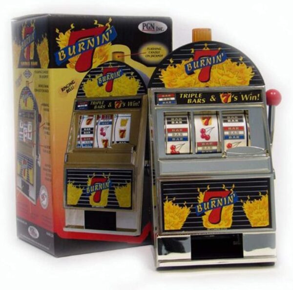 A Burning 7's Slot Machine Bank with Spinning Reels GETT Part CQS100 with a box next to it.