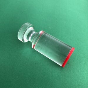A Roulette Win Marker with a red lid on a green surface.
