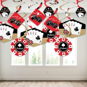 A Las Vegas - Casino Party Hanging Decor - Party Decoration Swirls - Set of 40 with poker chips and cards hanging from a window.