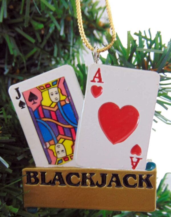A Blackjack Christmas Ornament hangs on a Christmas tree.