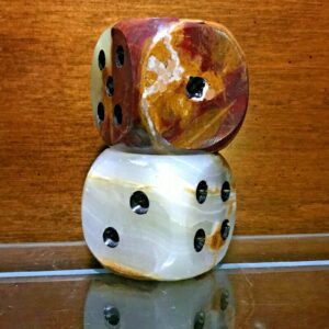 A set of Large Carved Onyx Mid-Century Modern Dice Sculpture sitting on a table next to each other.
