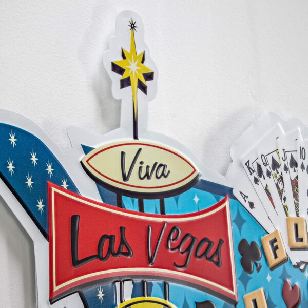 A Viva Las Vegas Royal Flush Embossed Metal Wall Decor Sign for Bar, Garage or Man Cave on a wall.