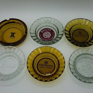 A group of Vintage Las Vegas Casino Ashtrays Bally's Castaways Peppermill Hilton with different logos on them.