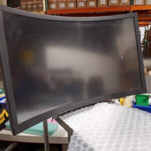 A 40" Curved LCD Touch Monitor for use with Novomatic Dominator Pro Curve sitting on a table in a warehouse.
