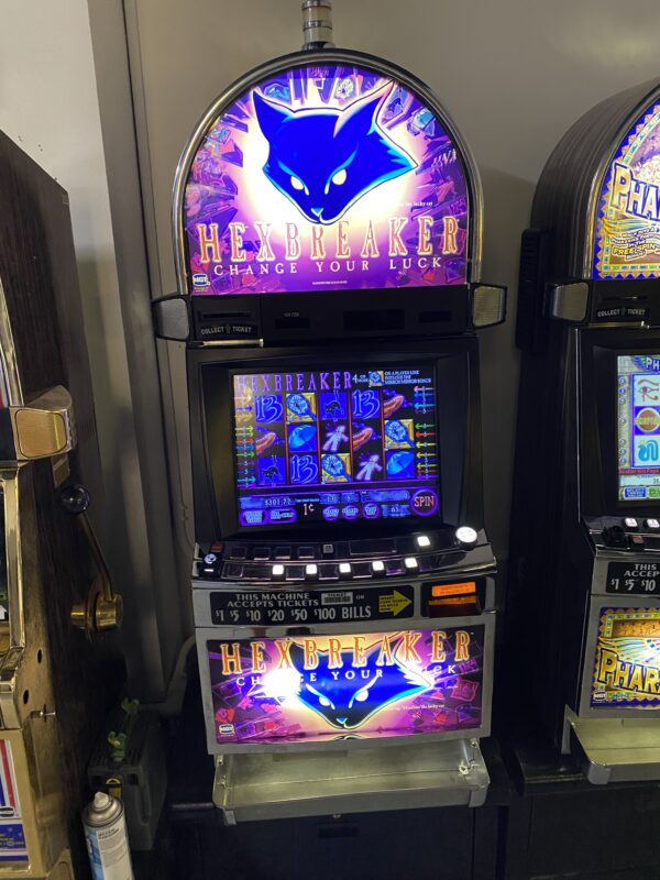 A group of slot machines with a cat on them.