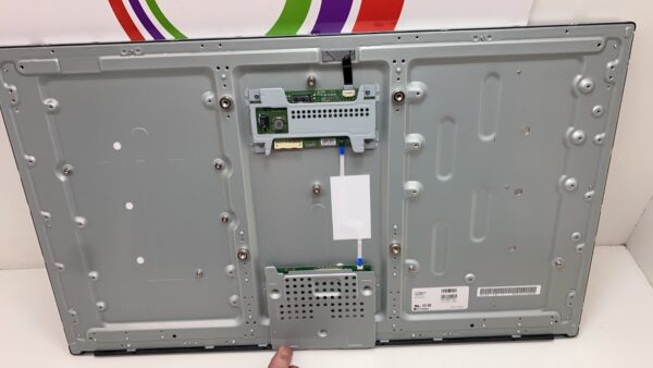 A person is holding up the back of a 32" LED Panel, LG Brand.