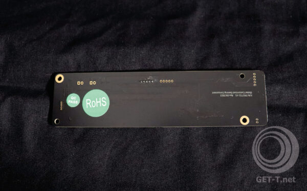A black pcb with a green logo on it.