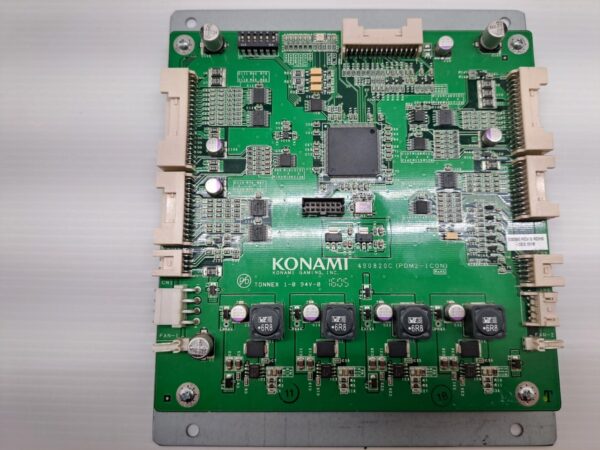 A green Power Control board for use with Konami Games on a white surface.