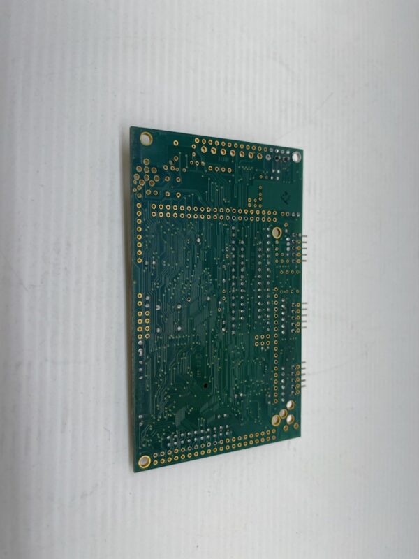 A green PCB with the Aristocrat Gaming SPC2.0 COMM Board on a white surface.