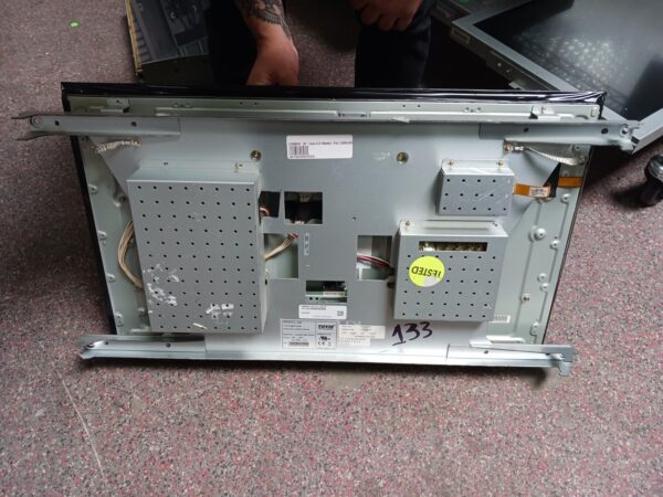 A man is removing the back of a 32" LDD Touch Monitor for use with Bally "Jumbo" games. TATUNG L32LD45M2W53A09. GETT Part LCDM410.