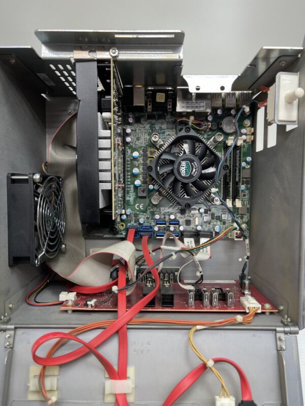 The inside of a CPU case with a fan and wires.
