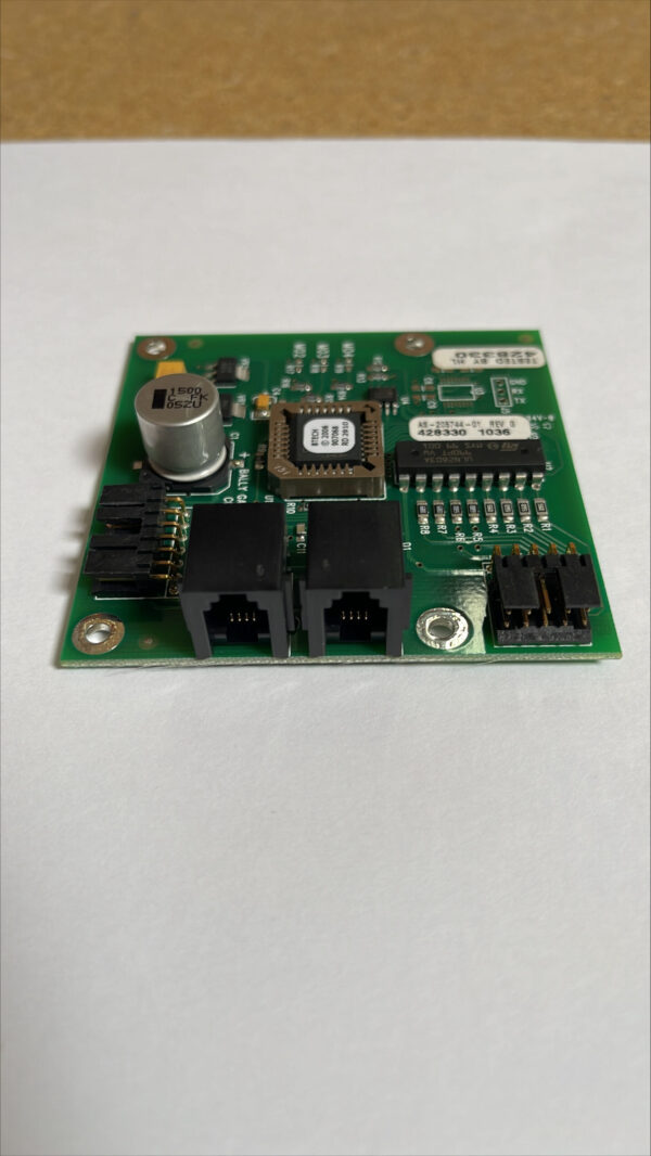 A small BALLY card reader AS-205744-01 Rev G - 428330 1036 GETT Part BIV120 with a small chip on it.